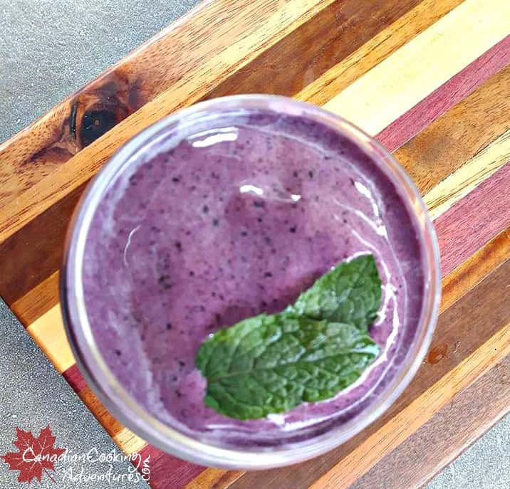 Frozen Blueberry Mojitos on a wood board