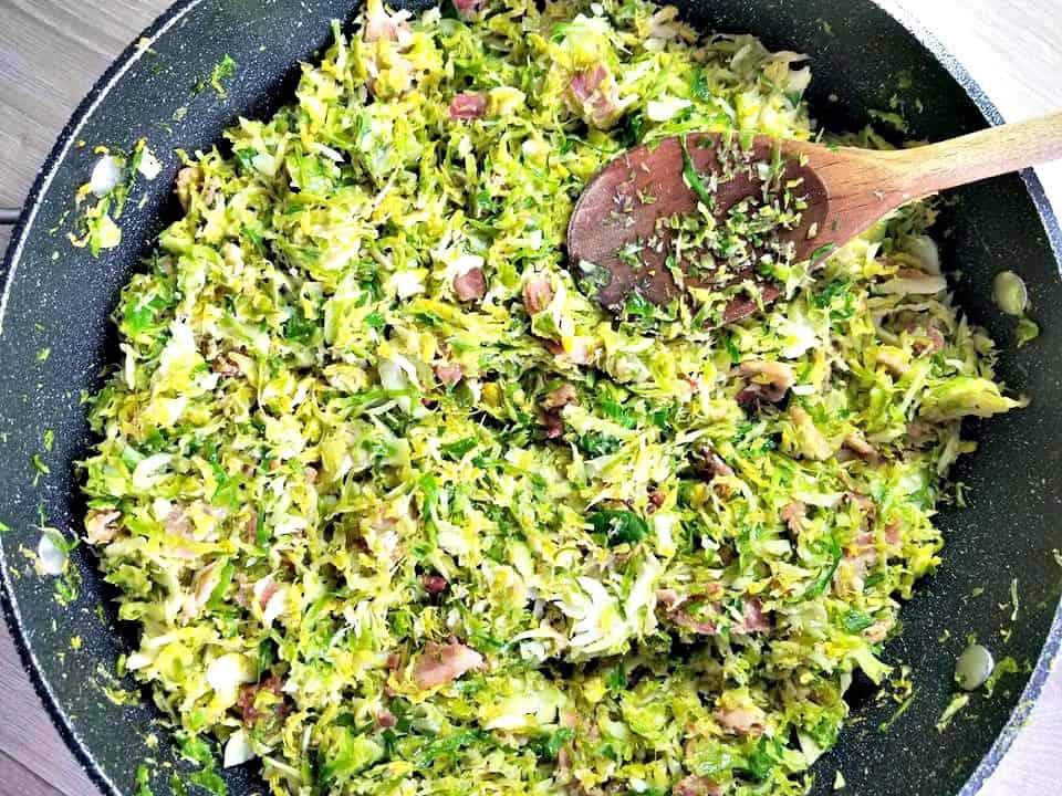 Shredded Brussel Sprouts in food processor in a frying pan