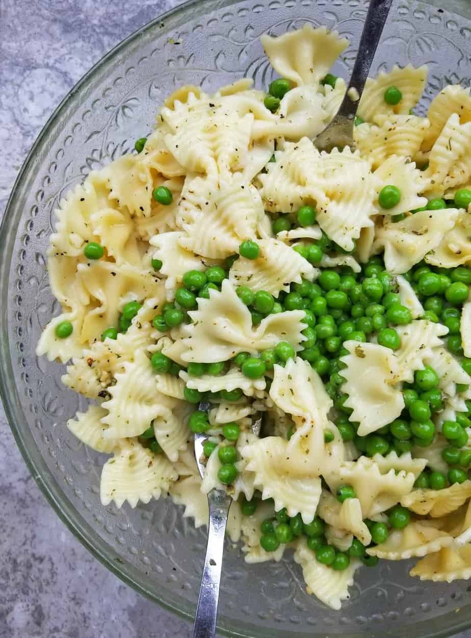 tossing the chicken pea pasta salad