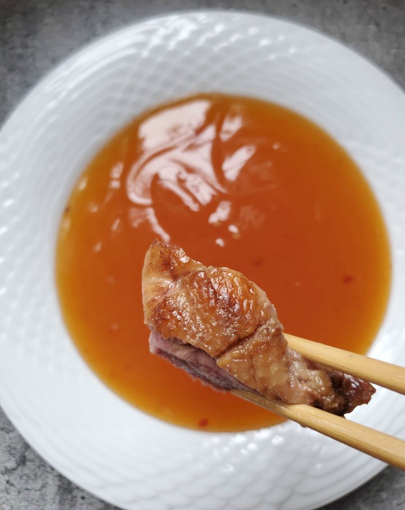 dipping the Chinese Rotisserie Duck in plum sauce